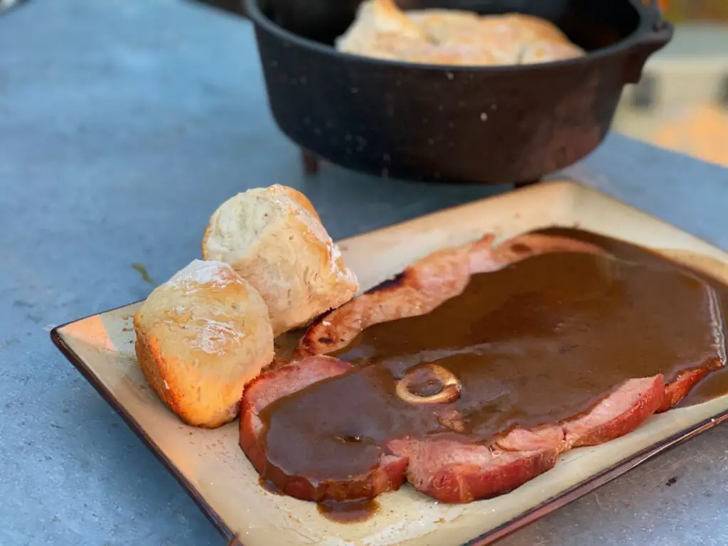 A plate of food with meat and bread on it.