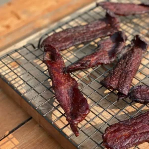 A close up of some bacon on a grill