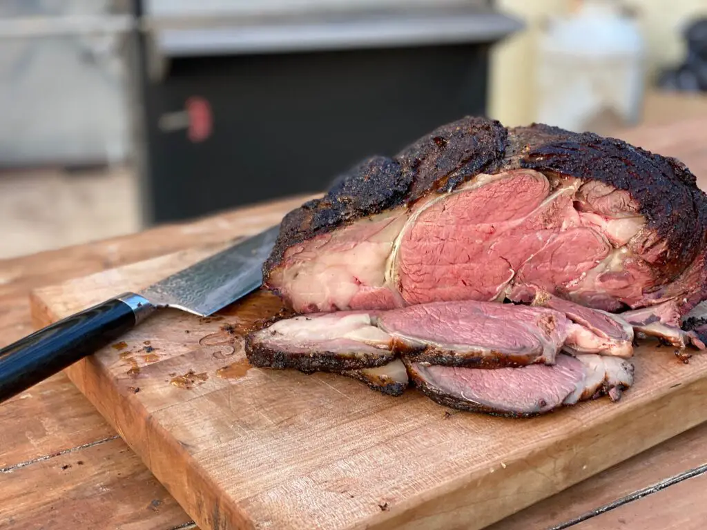 A large piece of meat on top of a cutting board.