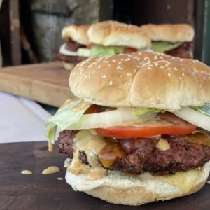 A close up of two burgers on a table