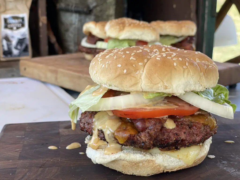 A close up of two burgers on a table