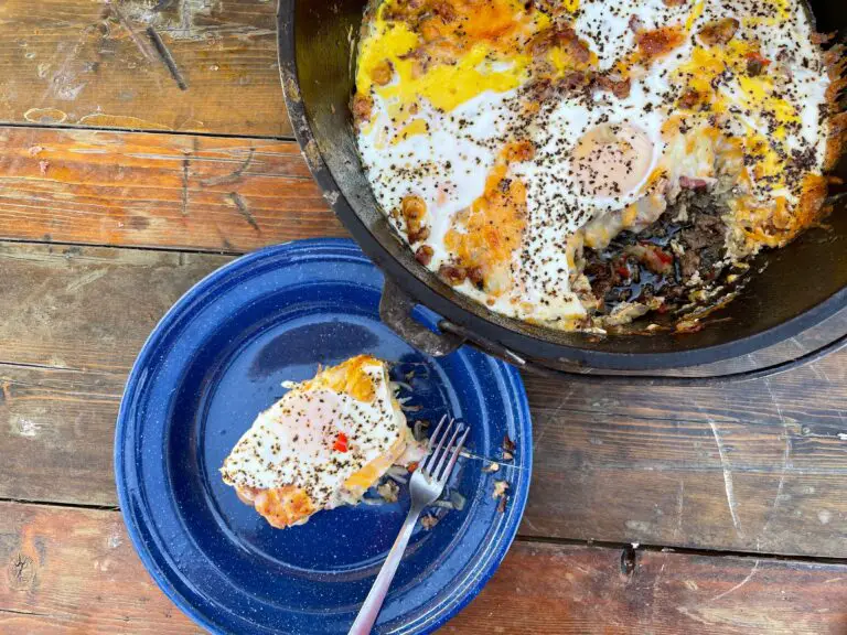 A blue plate and fork next to a pan of food.