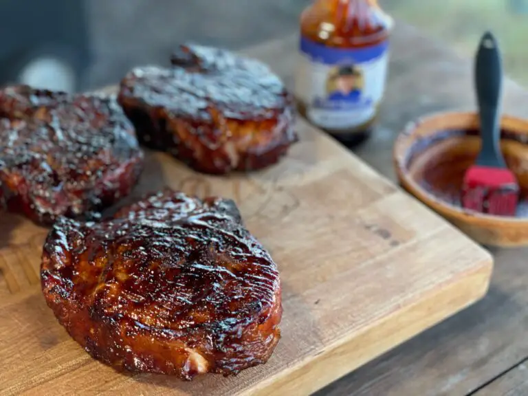 A wooden cutting board with some meat on it