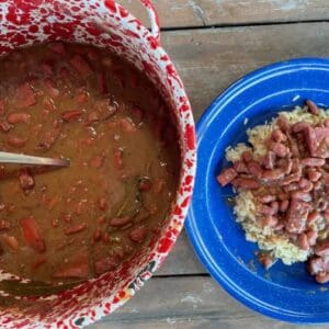 Red beans and rice with meat in a pot and plate.