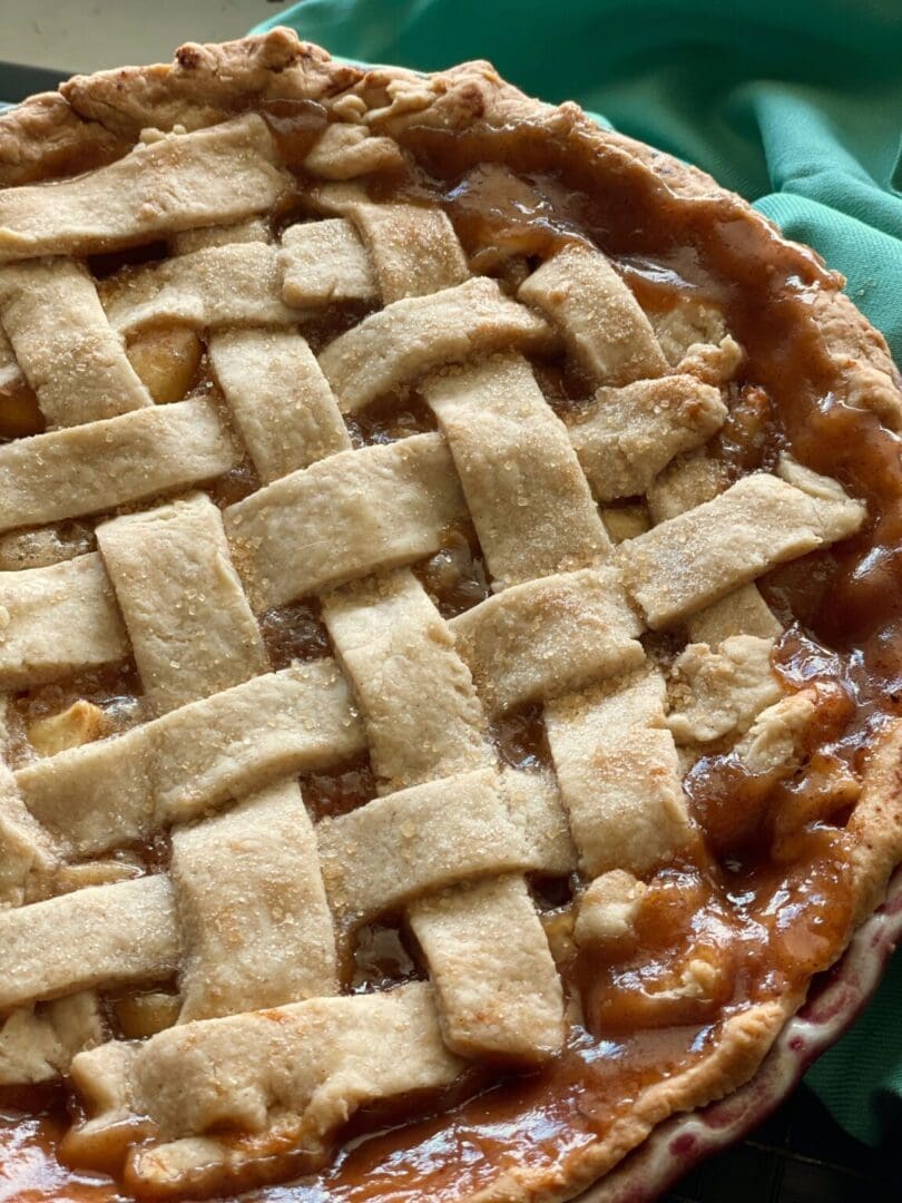 A close up of an apple pie with lattice crust.