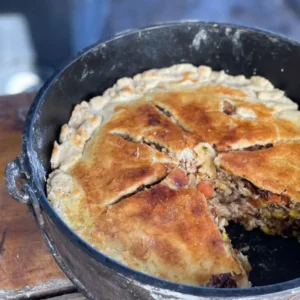 A pie in a pan sitting on top of a table.