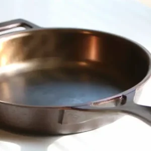 A pan with some oil in it on top of the stove.