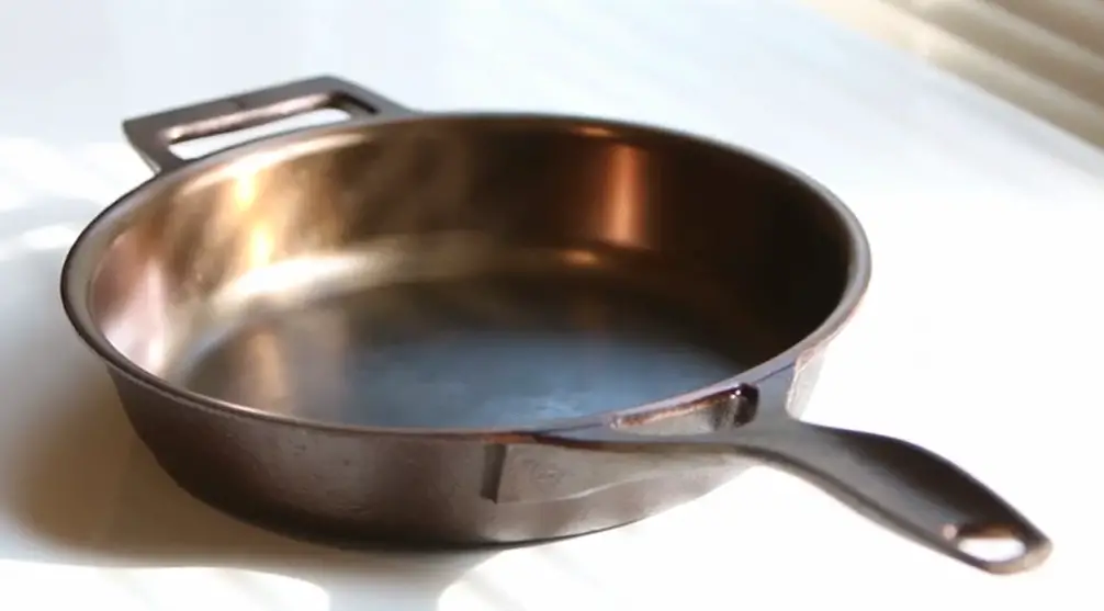 A pan with some oil in it on top of the stove.