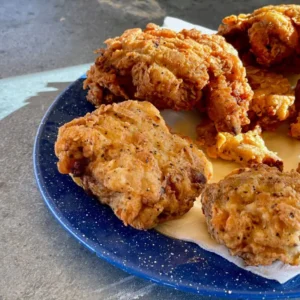 A plate of fried food on top of a table.