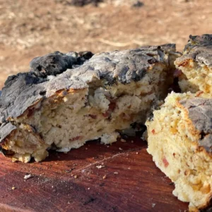 A piece of food that is on top of a wooden board.