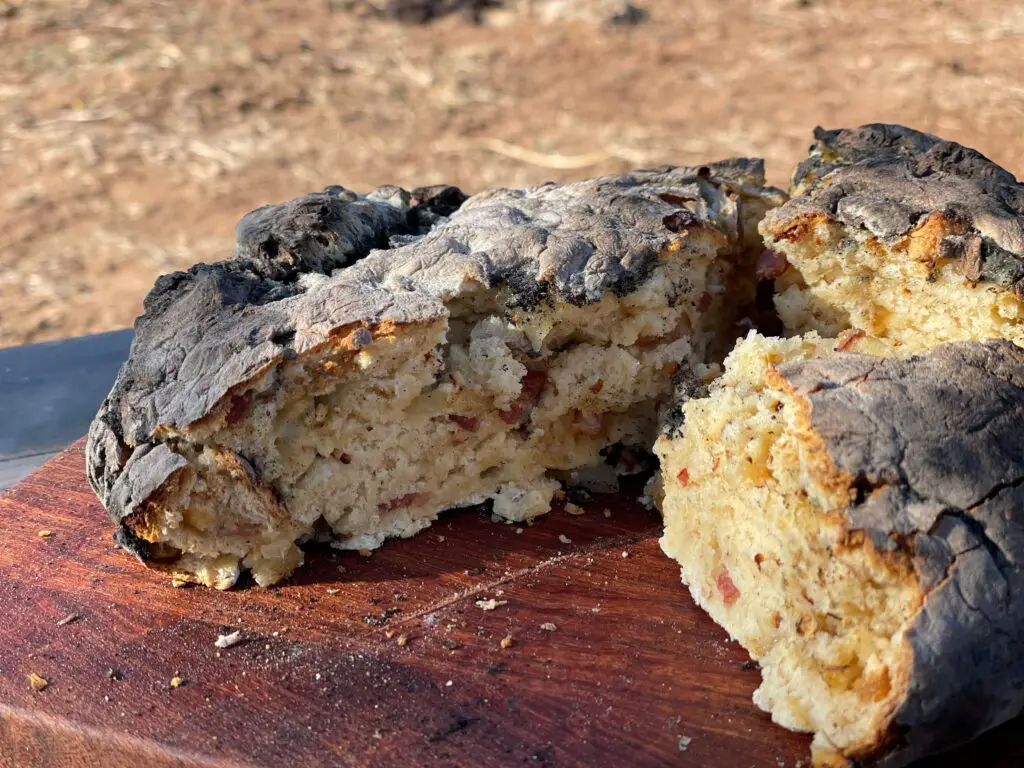 A piece of food that is on top of a wooden board.