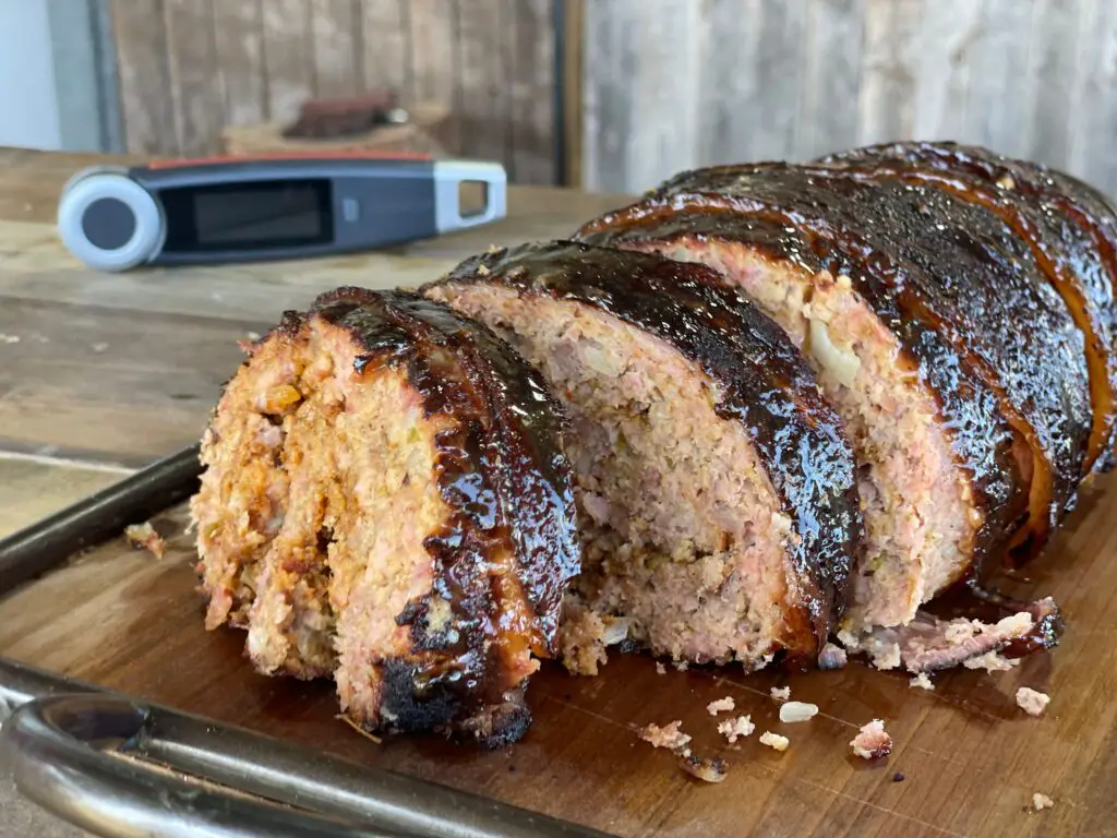 A close up of a loaf of meat on a cutting board