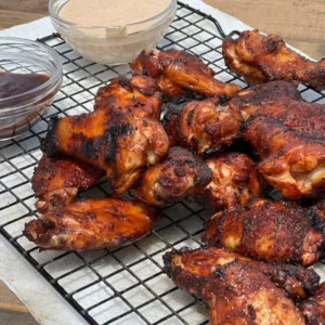 A grill with several different kinds of chicken.