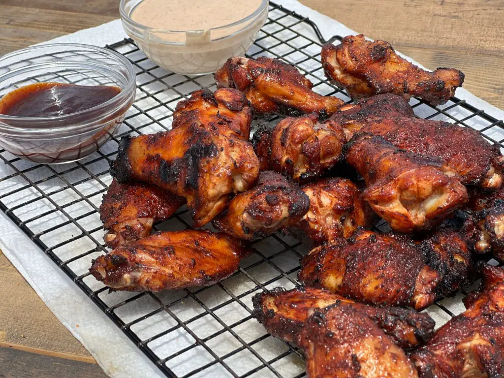 A grill with several different kinds of chicken.