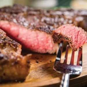 A close up of a fork and some meat