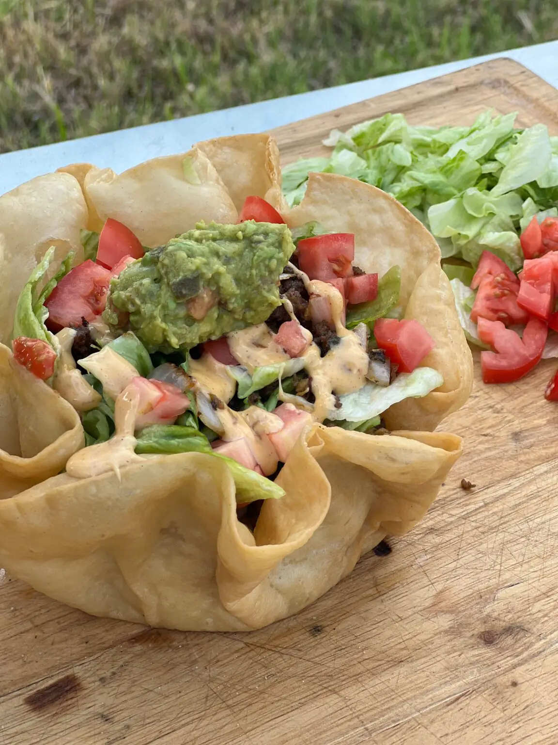 Taco salad with guacamole and lettuce.