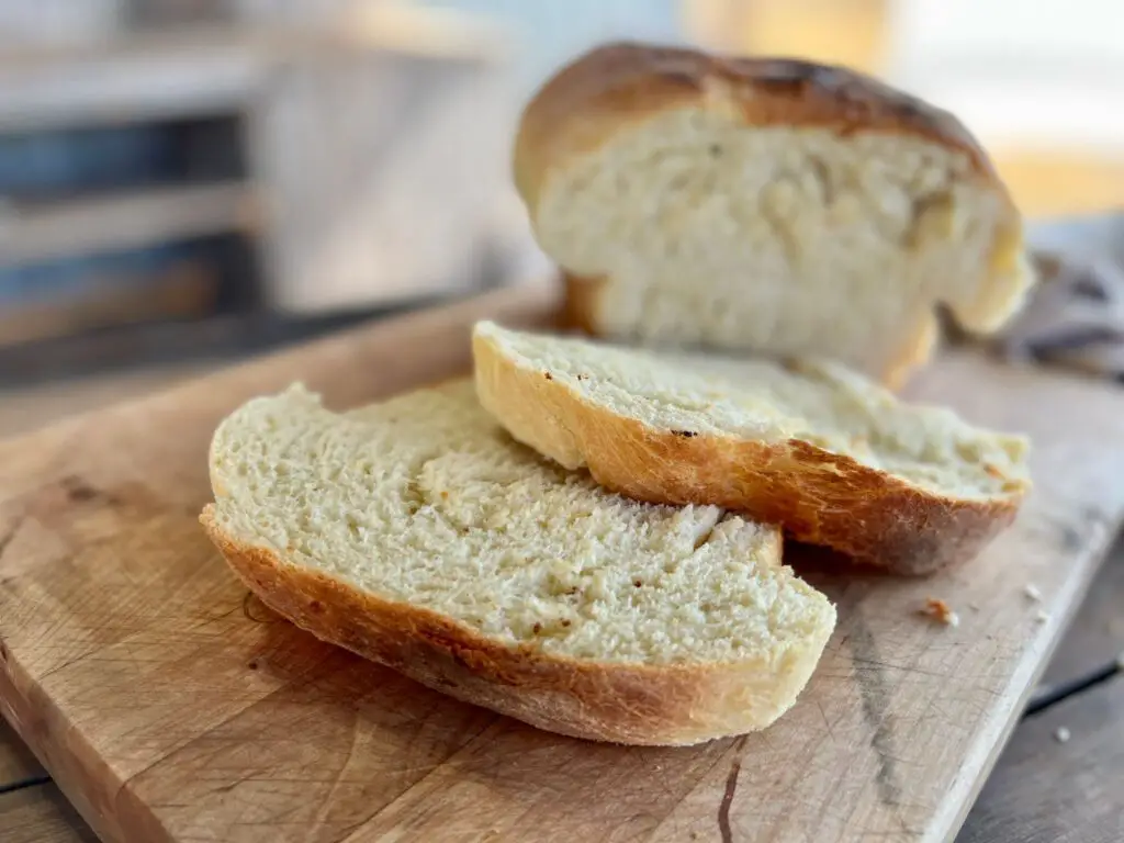 A close up of two pieces of bread on a cutting board