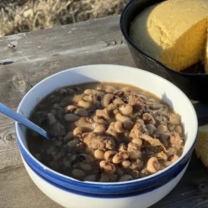 Black-eyed peas and cornbread on a table.