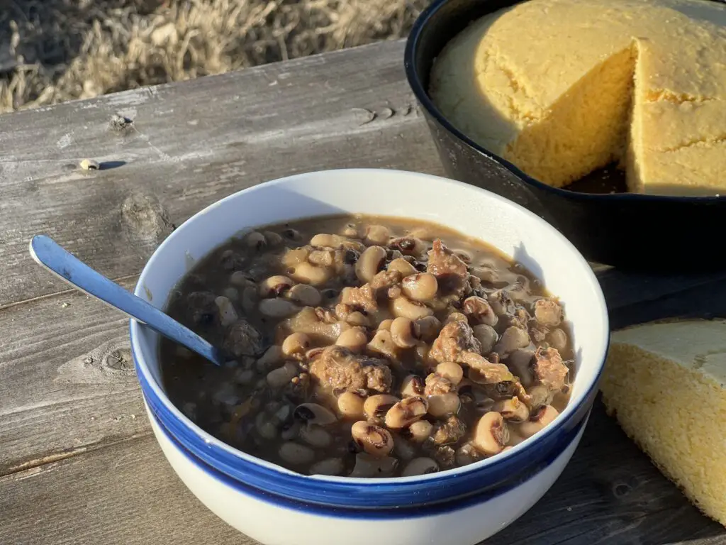 Black-eyed peas and cornbread on a table.