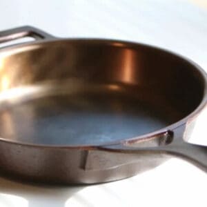 A pan with a handle on the bottom of it.