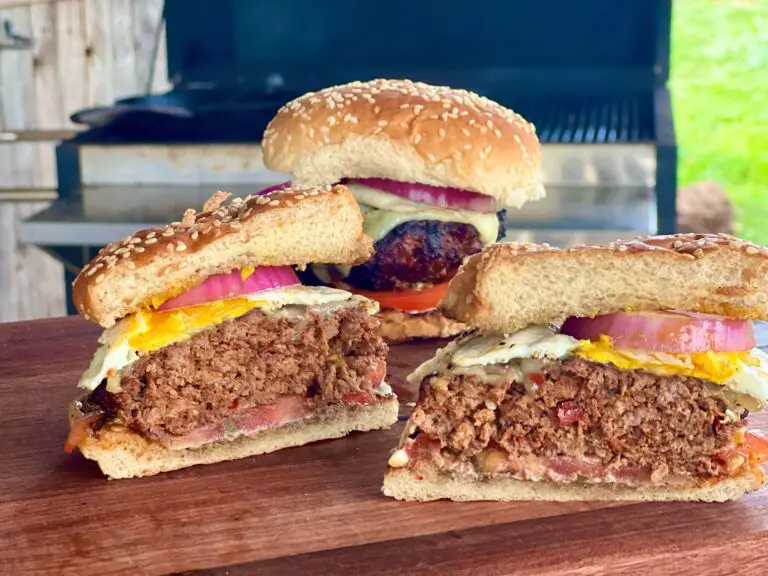 One full chorizo cheeseburger sits in the background between two halves of another chorizo burger.