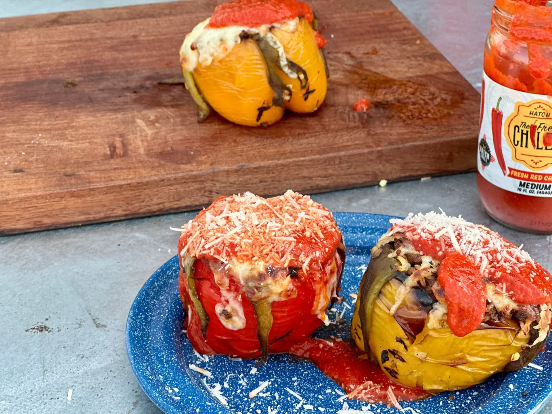 A blue plate with two stuffed peppers on it