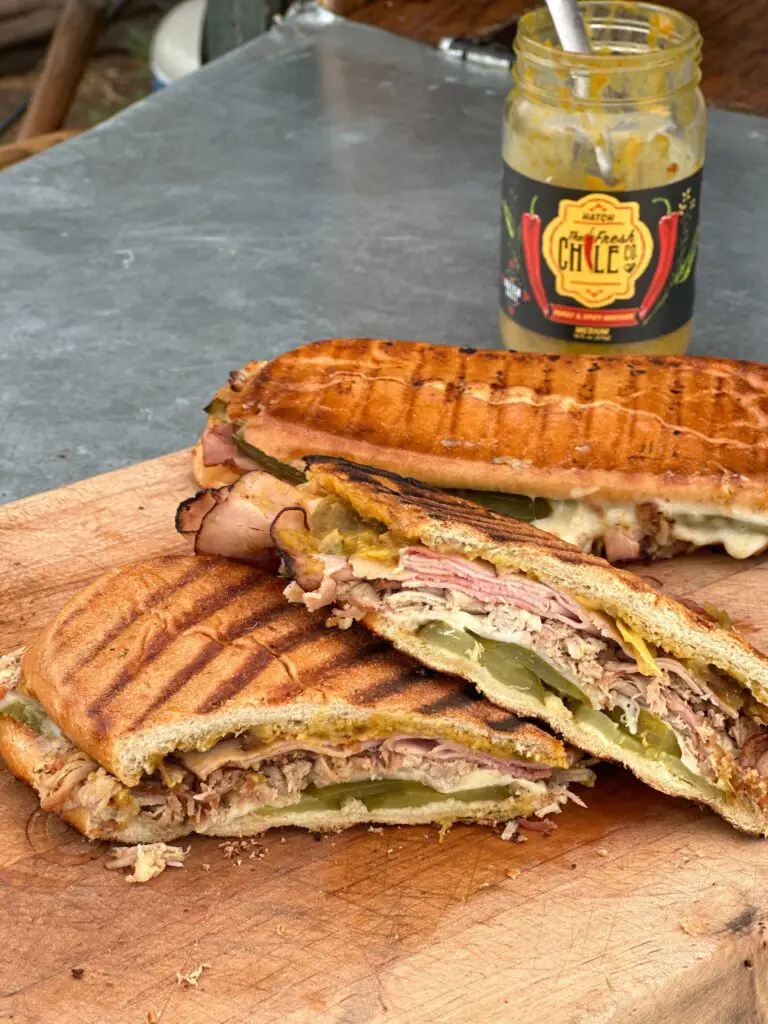 Kent Rollins Cowboy Cuban Sandwich grilled with a brick; sitting before the Fresh Chile Company Sweet and Spicy Mustard
