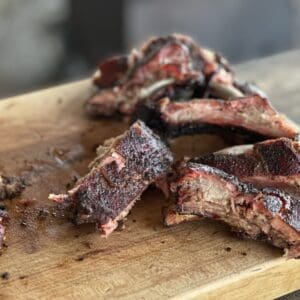 Smoked pork ribs on a wooden board.