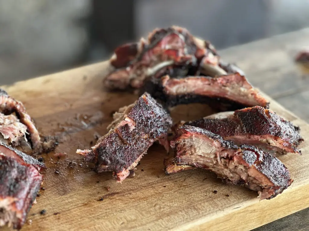 Smoked pork ribs on a wooden board.