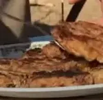 Grilled steak on a white plate.