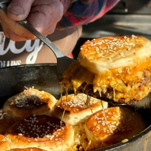 A person is cutting into some food in a pan