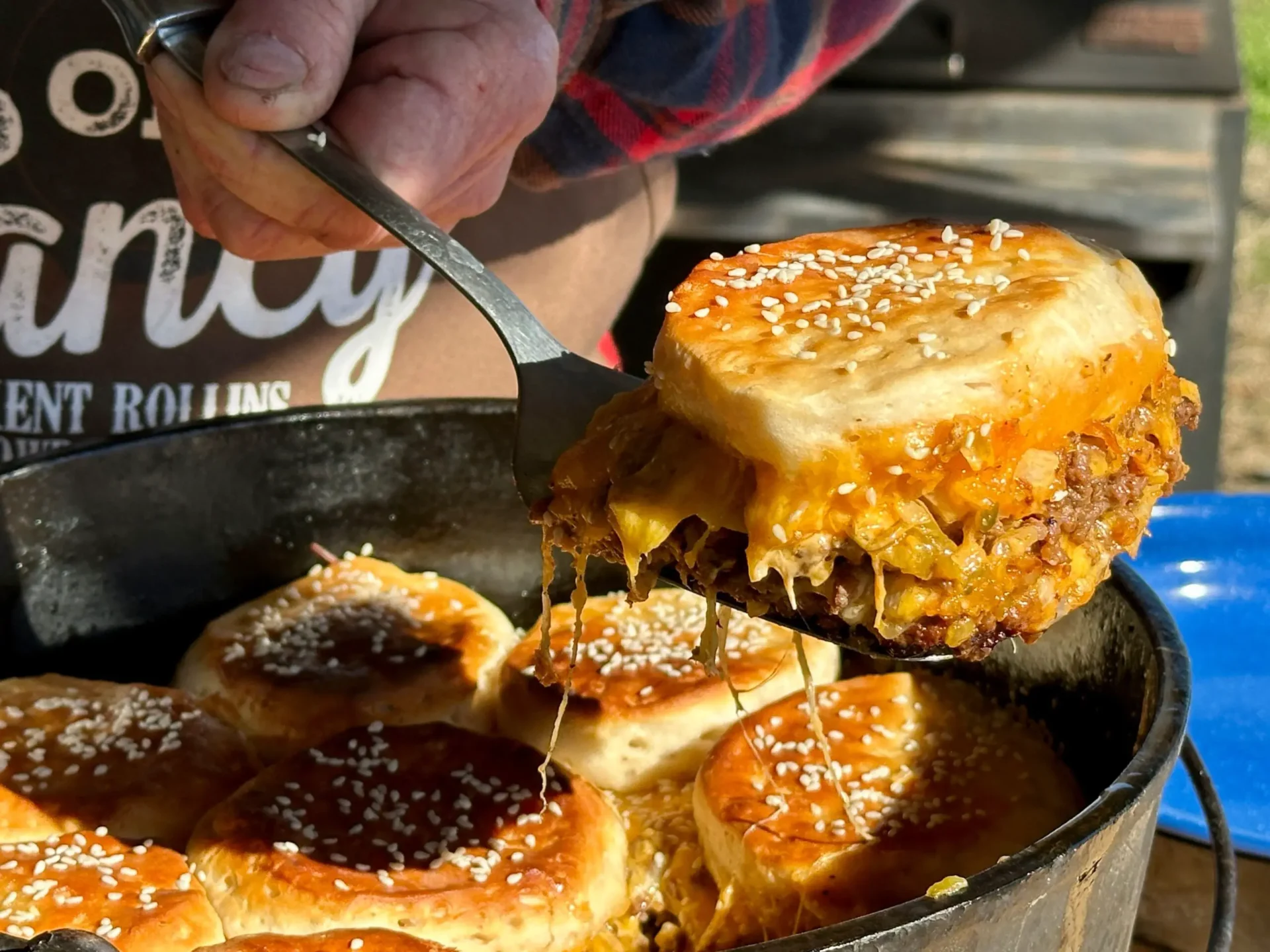 A person is cutting into some food in a pan