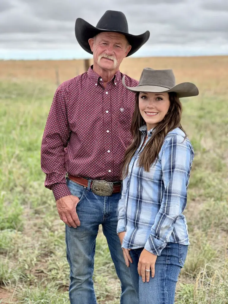 A man and woman in cowboy hats outdoors.