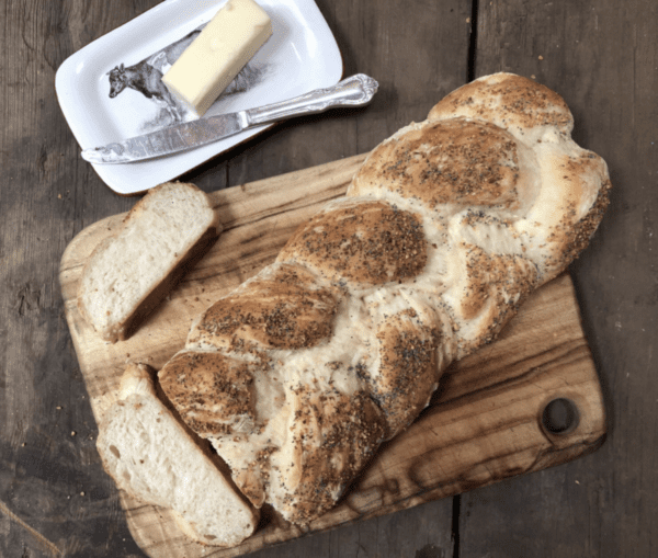 Braided loaf of bread with poppy seeds.