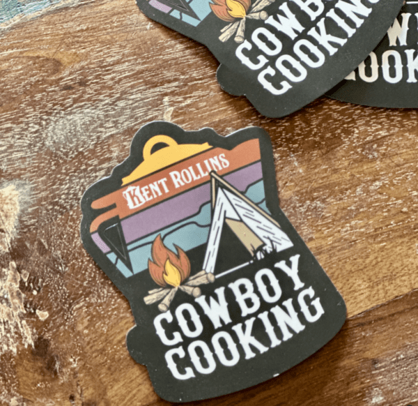 Cowboy cooking sticker with tent and campfire.