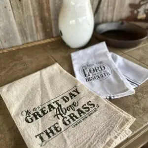 Two tea towels with sayings about faith and life.