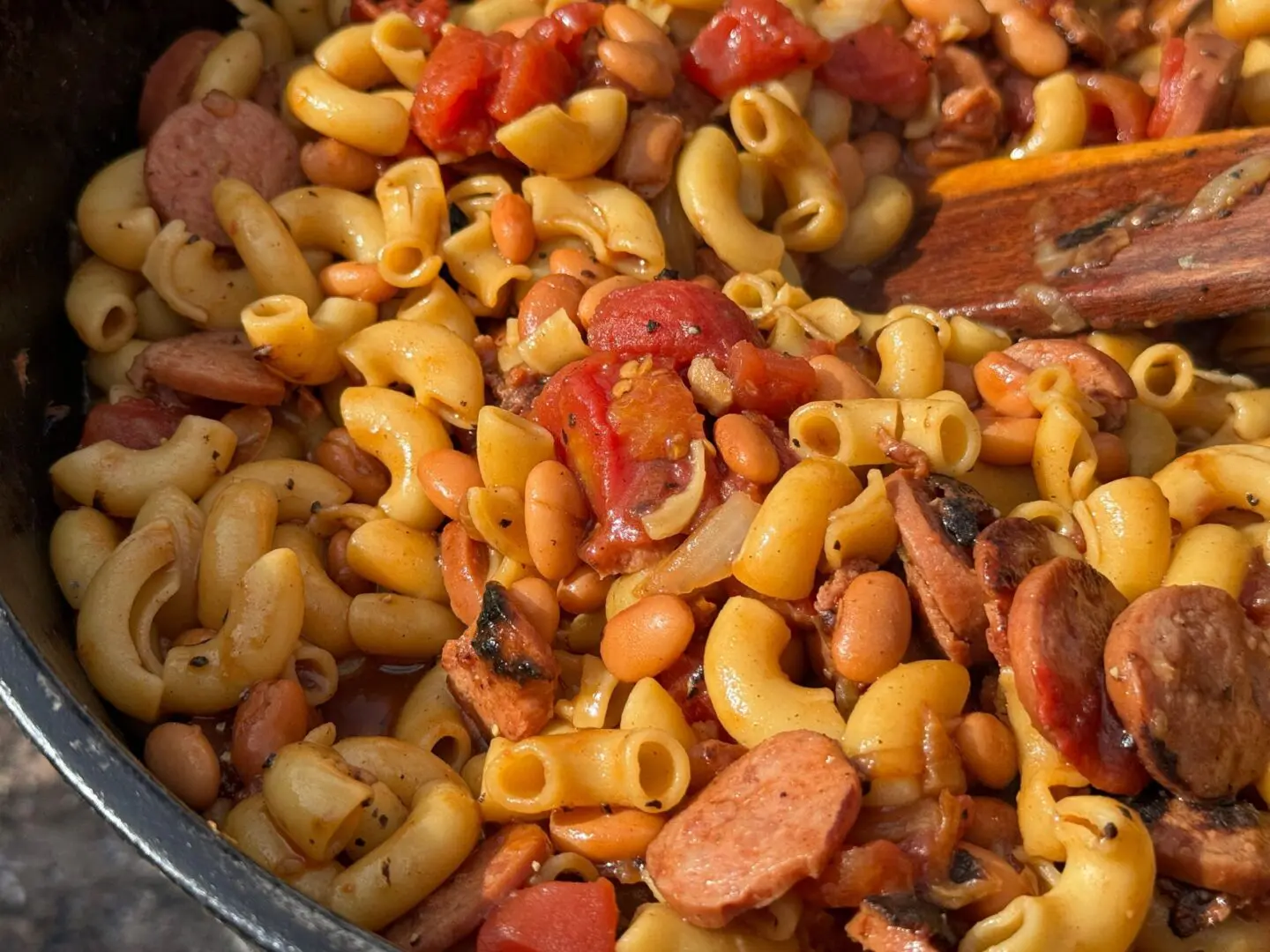 Macaroni and beans with sausage and tomatoes.