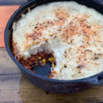 A pan of food with some meat and vegetables