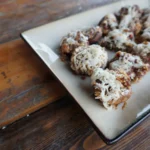 A plate of food on top of a wooden table.