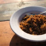 A bowl of food on top of a table.