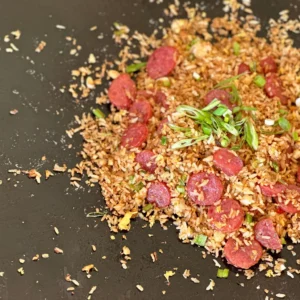 A pile of rice and meat on top of a table.