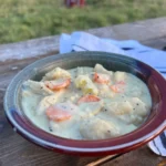 A bowl of food on top of a wooden table.