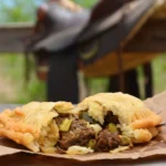 A close up of an open meat pie