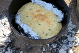 A pot with some food in it on the ground