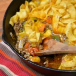 A pan of food with noodles and meat.