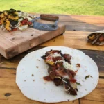 A pizza sitting on top of a white plate.