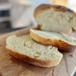 A close up of two pieces of bread on a cutting board