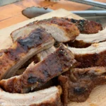 A close up of some meat on a cutting board