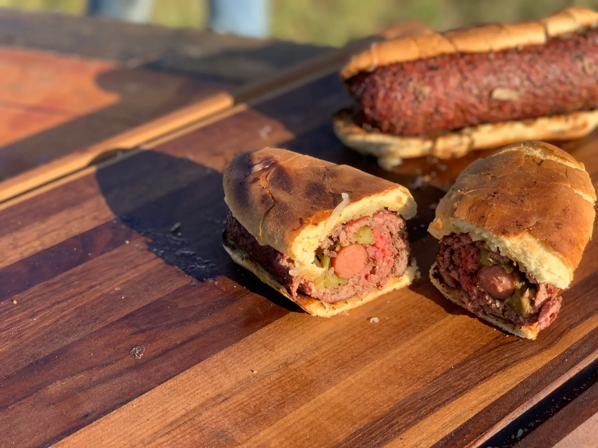 A close up of two sandwiches on a wooden table