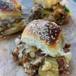 A close up of a sandwich on top of a wooden board